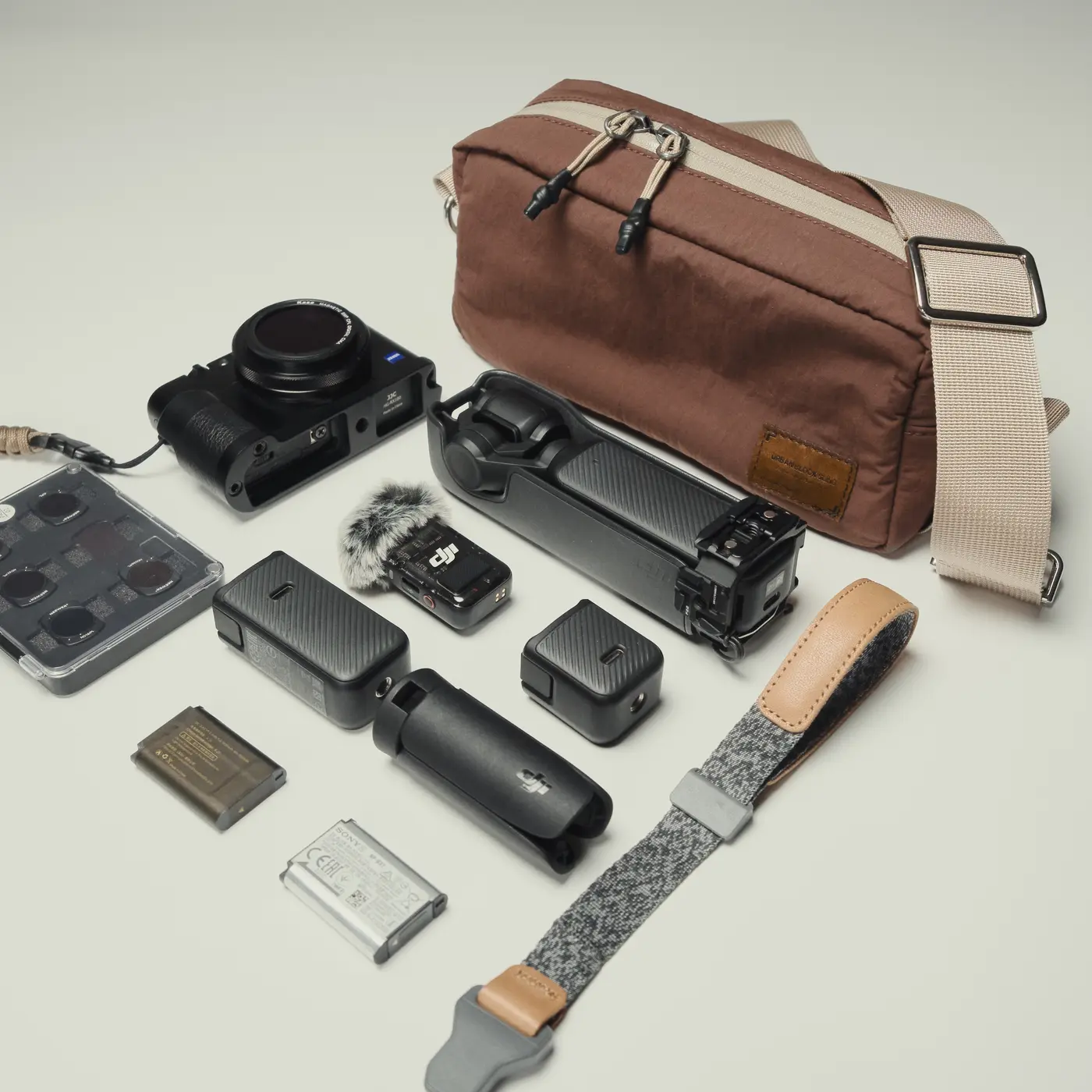 Urban Block Sling shown with camera and everyday essentials